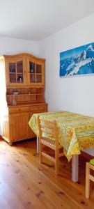 a room with a table and a dresser and a cabinet at Les Petites Maïs in Nantes-en-Rattier +7 photos