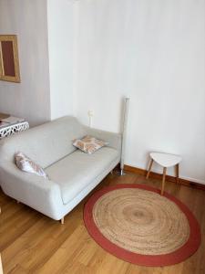 a living room with a couch and a rug at Blez kò in Vaucouleurs