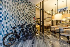 two bikes parked against a wall in a restaurant at Petit Palace Plaza de la Reina in Valencia