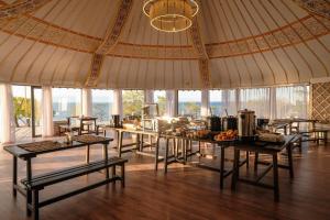 a large tent with tables with food on it at Ak-Sai Travel Oimo-Tash Yurt Camp in Kaji-Say +61 photos