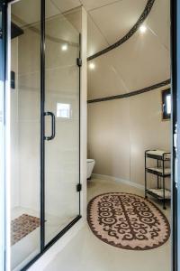a shower with a glass door in a bathroom at Ak-Sai Travel Oimo-Tash Yurt Camp in Kaji-Say