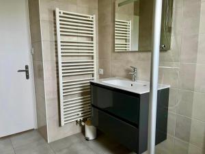 a bathroom with a sink and a mirror at Les Cabines de la Vie in Saint-Gilles-Croix-de-Vie