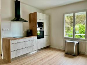 a kitchen with a stove top oven next to a window at Les Cabines de la Vie in Saint-Gilles-Croix-de-Vie