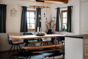 a dining room with a wooden table and chairs at Chalupa Mariánská hora 776 in Jablonec nad Nisou +18 photos