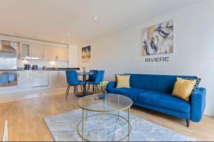 a living room with a blue couch and a table at Bright 2-BDR Apartment - Prime Central Location - Free Wi-Fi in Birmingham