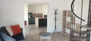 a living room with a couch and a kitchen at La Dépendance d'En Face in Huppy
