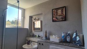 a bathroom with a sink and a glass shower at Klein aber fein in Hinterweidenthal