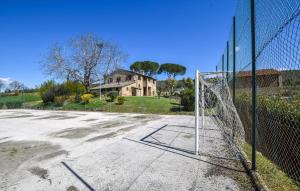 an empty parking lot with a basketball hoop on a fence at Umbria Magione Podere C in Magione