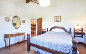 a bedroom with a bed and a table and a mirror at Umbria Magione Podere C in Magione