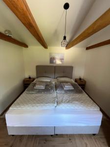 a bedroom with a large bed in a room at Apartman River in Belišće
