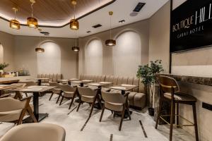 a large dining room with tables and chairs at Boutique Hill Hotel in Požarevac