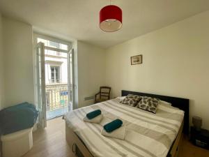 a bedroom with a bed with pillows and a window at appartement centre ville in Souillac