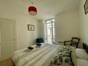 a bedroom with a bed in a room with a window at appartement centre ville in Souillac +9 photos