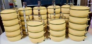 a group of yellow drums sitting on a table at Kiangnapa Cottage in Kanchanaburi City