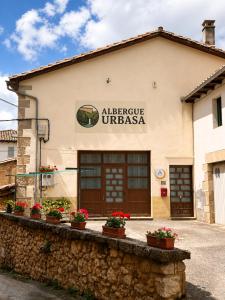 a building with a sign that reads alpine urza at Albergue Urbasa -No se comparte, alojamiento entero in Eulate