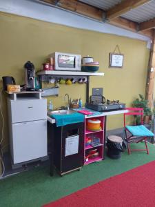 a kitchen with a counter and a sink in a room at Le Passager Cilaos maison privée in Cilaos +2 photos