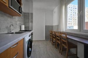 a kitchen with a sink and a washing machine at Comfort 65 2-Bedroom Apartment with Balcony in Miskolc +8 photos