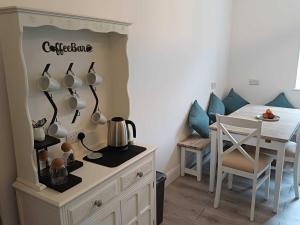 a kitchen and dining room with a table and a table and a dining room at An Mor Haven in Coverack