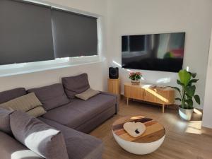 a living room with a couch and a table at Casa Rural El Pinar de Jesus in Arcos de la Frontera