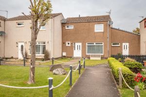 a house with a fence in front of it at Dreelside - No 50 in Anstruther