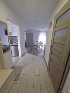 a hallway with a door leading to a living room at Dom w dolinie in Zagórz +10 photos