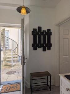 a living room with a table and a staircase at An Mor Haven in Coverack