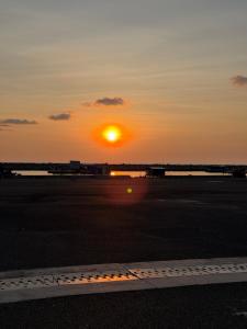 a sunset at an airport with the sun setting at Libra House Phu Quoc in Phú Quốc