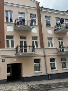 a large building with a door and balconies on it at Studio Centrum in Chełm