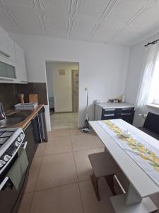 a kitchen with a counter and a table in it at Dom w dolinie in Zagórz
