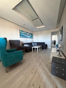 a living room with a couch and a table at Apartament Wczasowa 3 in Sarbinowo