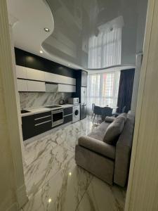 a living room with a couch and a kitchen at ЖК Акварель 2 in Odesa