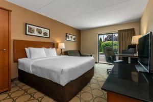 a hotel room with a bed and a television at Comfort Inn Cobourg - Port Hope in Cobourg