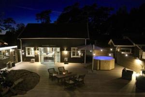 a patio with a table and chairs at night at Gottskär Hotell & Konferens in Onsala