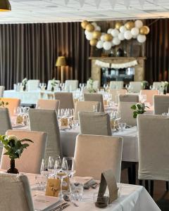 a dining room with white tables and chairs at Gottskär Hotell & Konferens in Onsala +61 photos