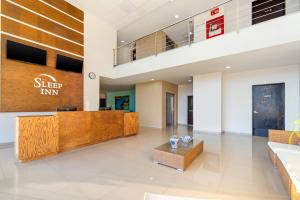 an office lobby with a desk in a building at Sleep Inn Mazatlan in Mazatlán +57 photos