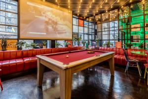 a pool table in a bar with red couches at Stay Central Hotel in Edinburgh