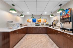 a large kitchen with wooden cabinets and aasteryasteryasteryasteryasteryasteryasteryastery at Comfort Inn Pikeville in Pikeville