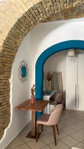 a dining room with a table and a chair at Barbarossa Sea Room in Termoli