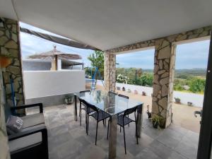 a dining room with a glass table and chairs at LAS TRES ROSAS in Vejer de la Frontera
