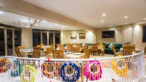 a dining room with tables and chairs in a restaurant at Bhalil Farm House in Sefrou