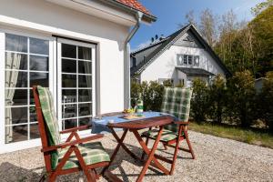a table and two chairs on a patio at Strandhaus zum Lotsenturm in Thiessow