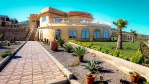 a house with a palm tree in front of it at Bhalil Farm House in Sefrou