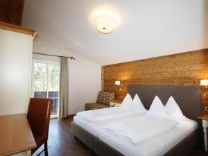 a hotel room with a white bed and a window at Vacation home in Flachau in Flachau