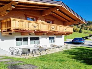 a house with a deck and a table and chairs at Vacation home in Flachau in Flachau