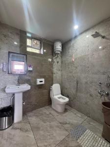 a bathroom with a toilet and a sink at ZuZu Hostels Mcleodganj in Dharamshala +11 photos