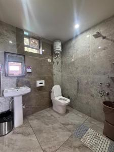 a bathroom with a toilet and a sink at ZuZu Hostels Mcleodganj in Dharamshala