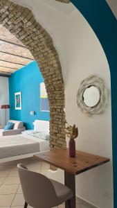 a bedroom with a bed and a table with a chair at Barbarossa Sea Room in Termoli