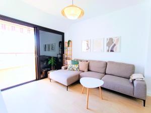 a living room with a couch and a table at Cozy & Terrace Apartament5 in Los Cristianos