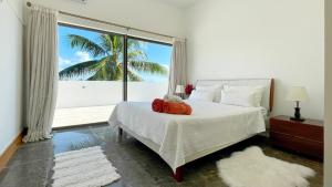 a bedroom with a bed with a teddy bear on it at Beach Penthouse BELMARE in Belle Mare +52 photos