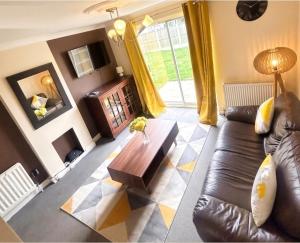 a living room with a couch and a coffee table at 2 Bed Semi - Sleeps 4 - Fully Fenced Garden & Parking - Quiet Cul De Sac Location - Dog Friendly - Fast Wifi - Close to Motorway Access in Doncaster